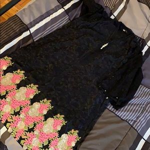 Black one piece kurta with sequins on the border.